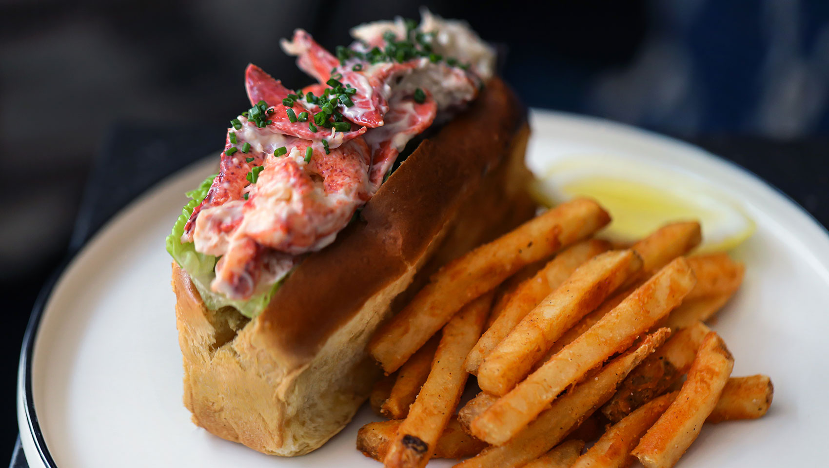 Lobster roll with fries on a plate