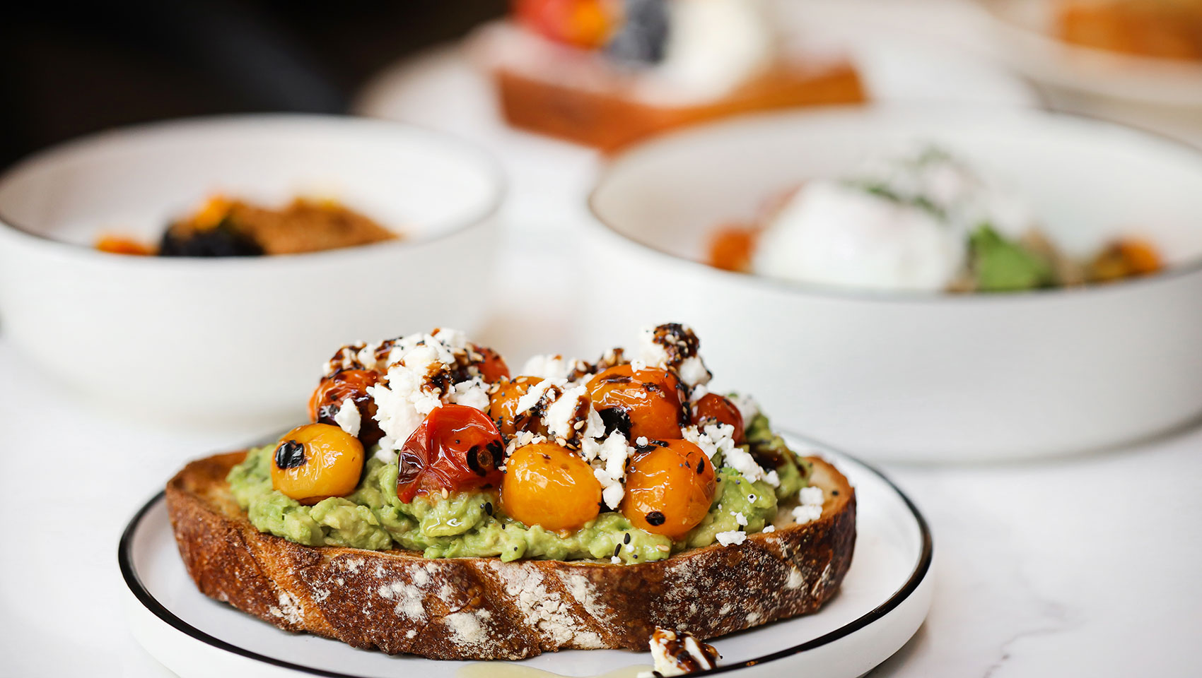 Avocado toast with toppings on plate