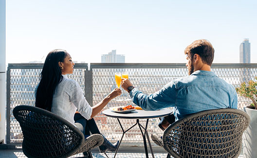 couple having a drink on the balcony